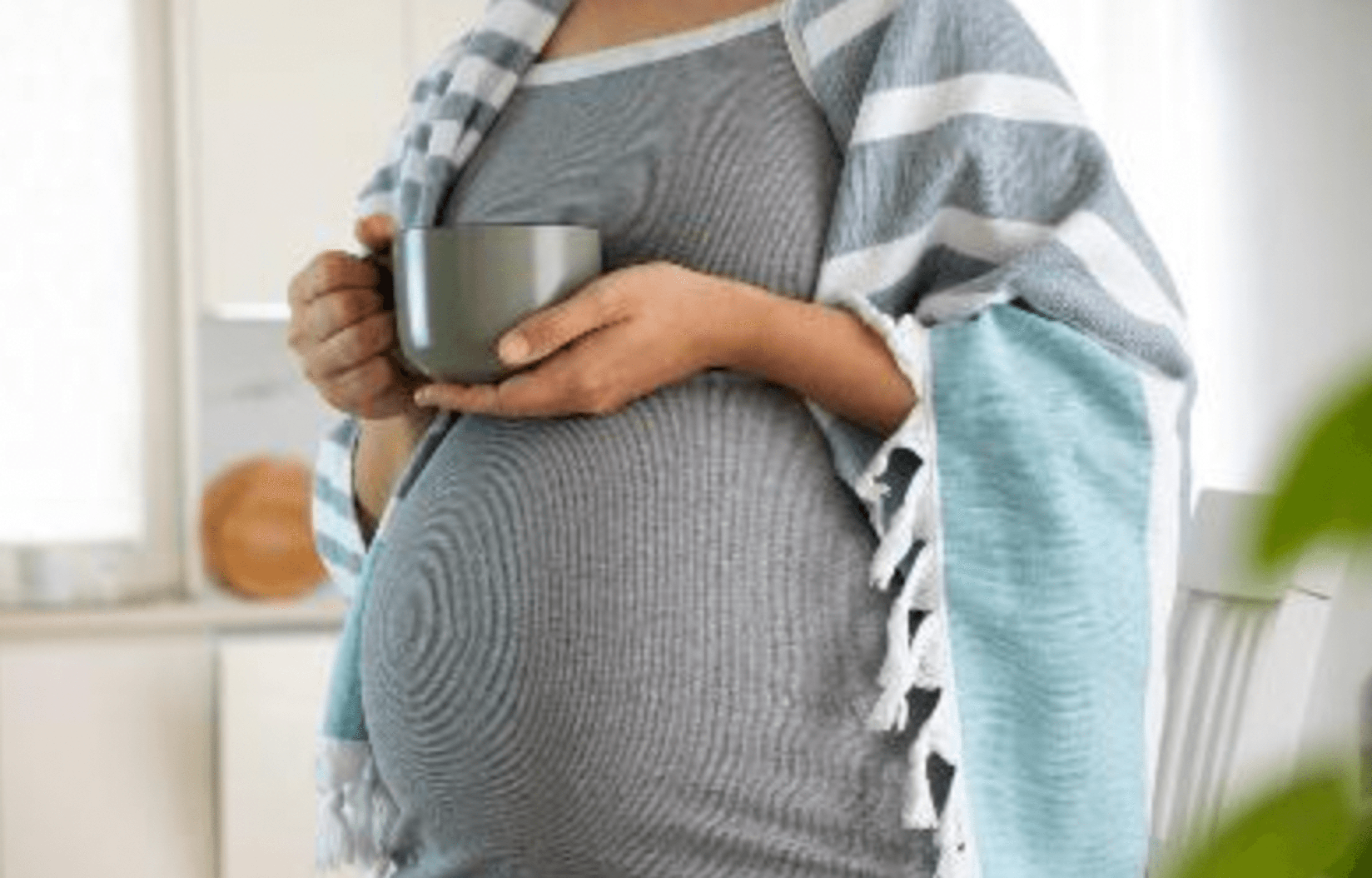 pregnant woman holding a mug